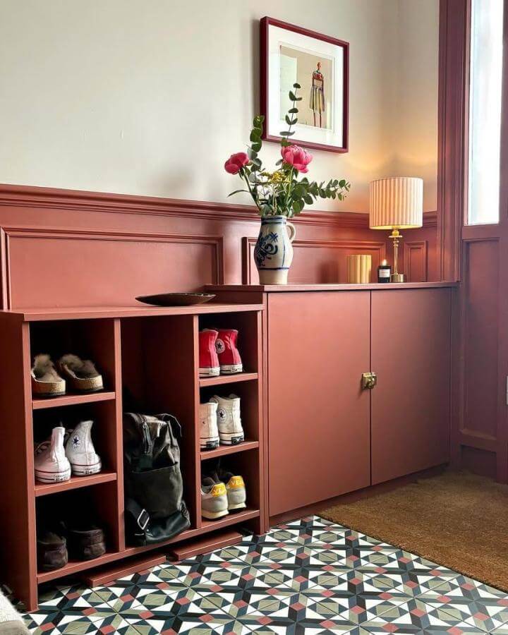 Terracotta bespoke entryway shoe storage unit with open shelving and closed cabinets by @fromlondontomanchester. Stylish and functional organization piece.