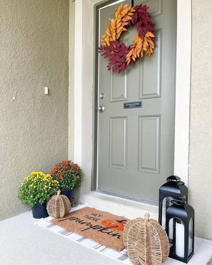 Colorful leaf wreath and porch setup showcasing creative fall front porch decor ideas with seasonal styling.