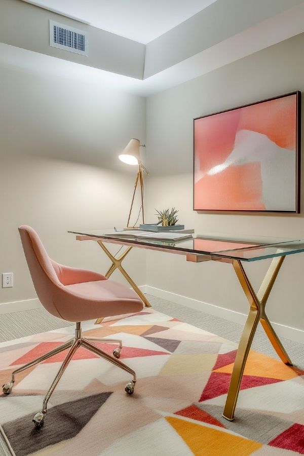 Feminine home office with pastel decor, cozy chair, floral accents.