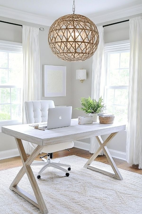 Feminine home office with pastel decor, floral accents, chic furnishings.