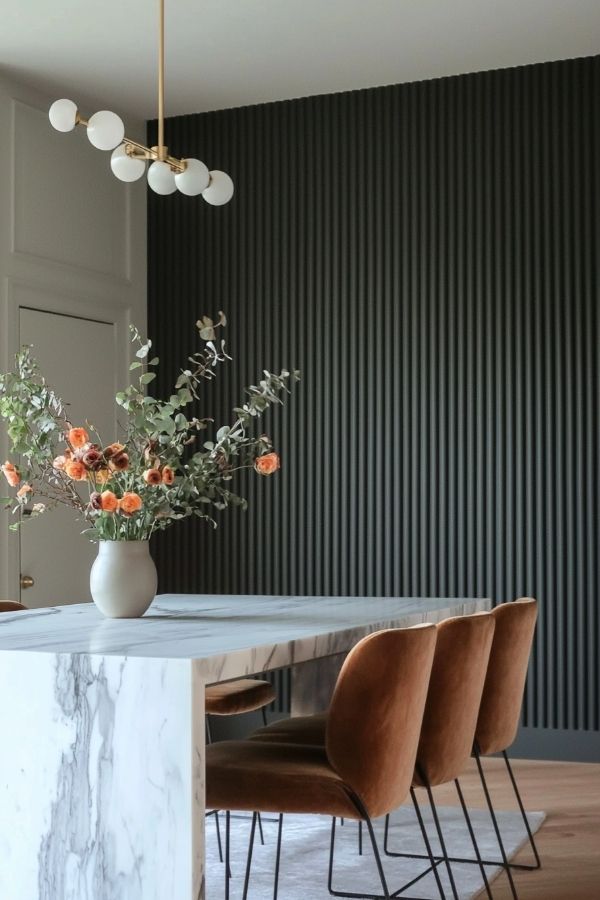 Elegant marble dining table with sleek black panel backdrop. Modern design.