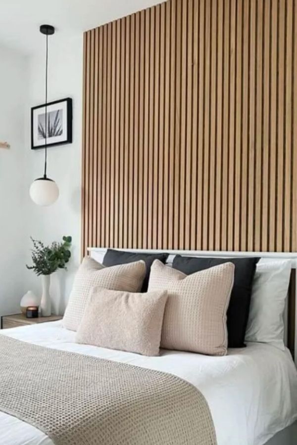 Minimalist bedroom featuring a fluted headboard, neutral colors, and simplicity.