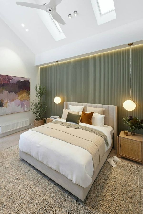 Modern bedroom featuring elegant green fluted wall and minimal decor.