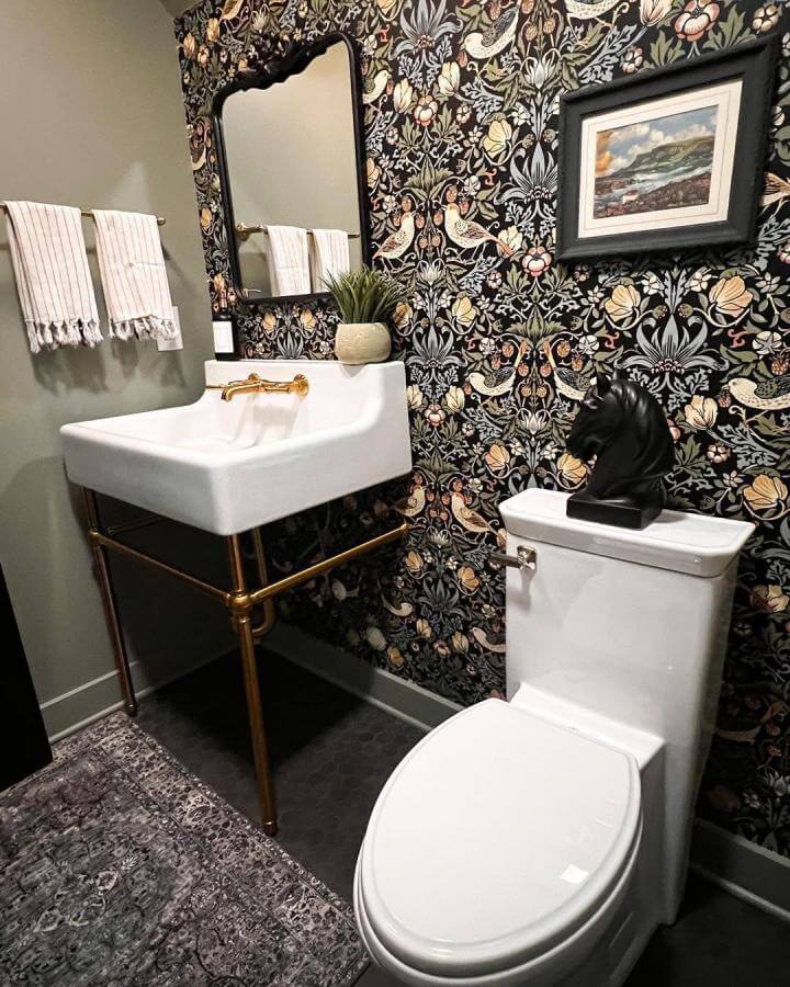 Dark floral wallpaper bathroom with brass fixtures and black horse bust by @elainecitrohome funky bathroom ideas