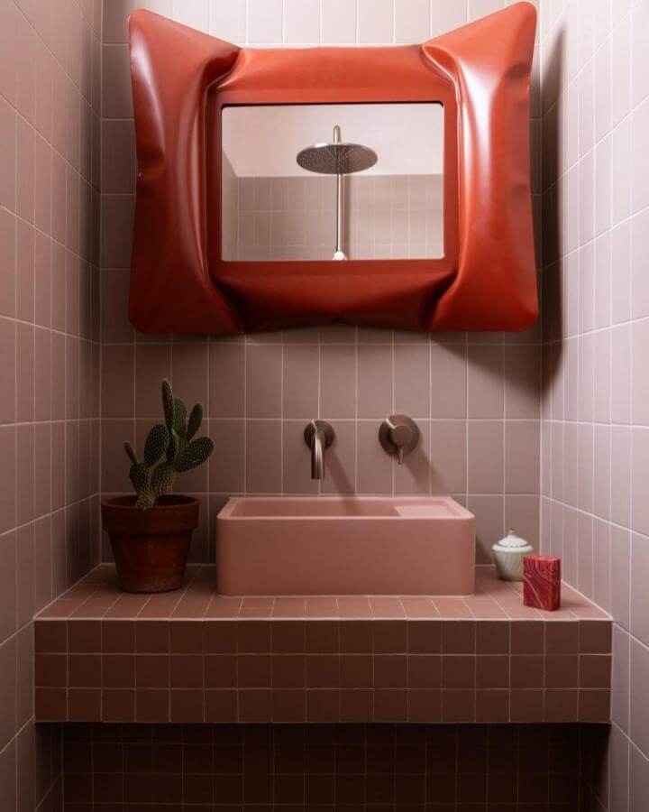 Burnt sienna sculptural mirror with pink tiled bathroom and cactus from @jessicaalice_design funky bathroom ideas.