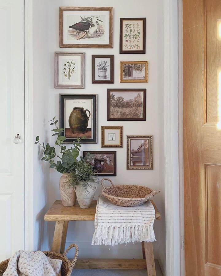 Warm wood framed vintage botanical prints gallery wall with natural textures and woven baskets from @athomewithfran in a cozy corner.