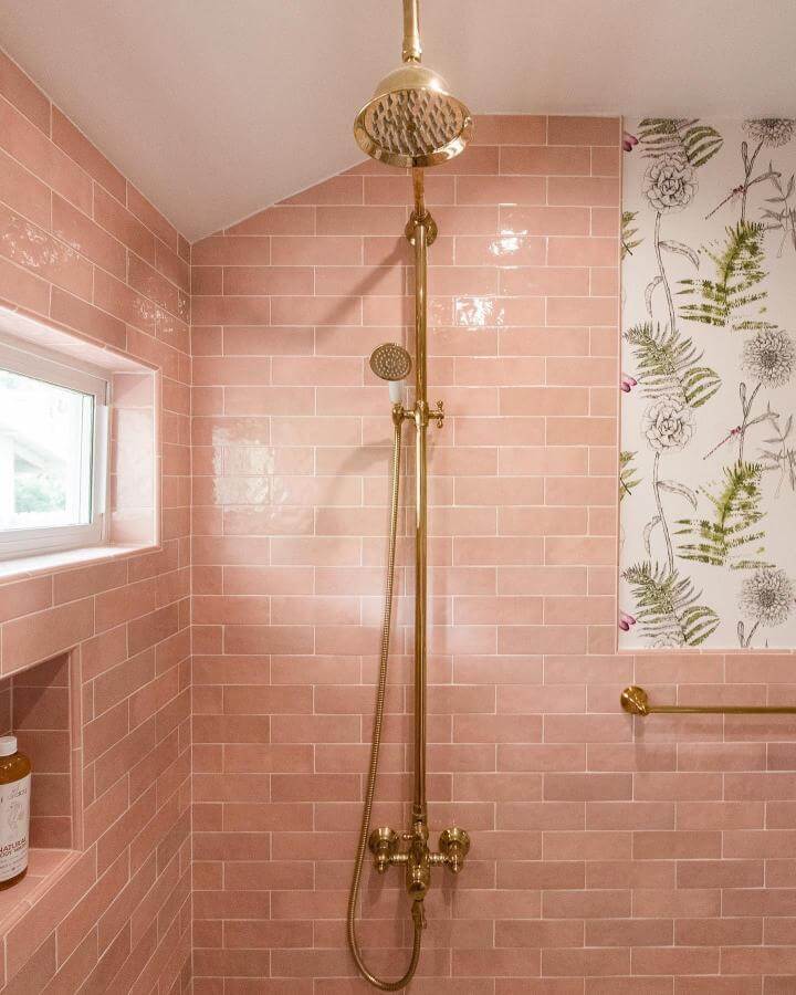 blush pink subway tile bathroom shower with brass fixtures and floral wallpaper from @northcountytileandstone girly bathroom ideas bright and inviting space