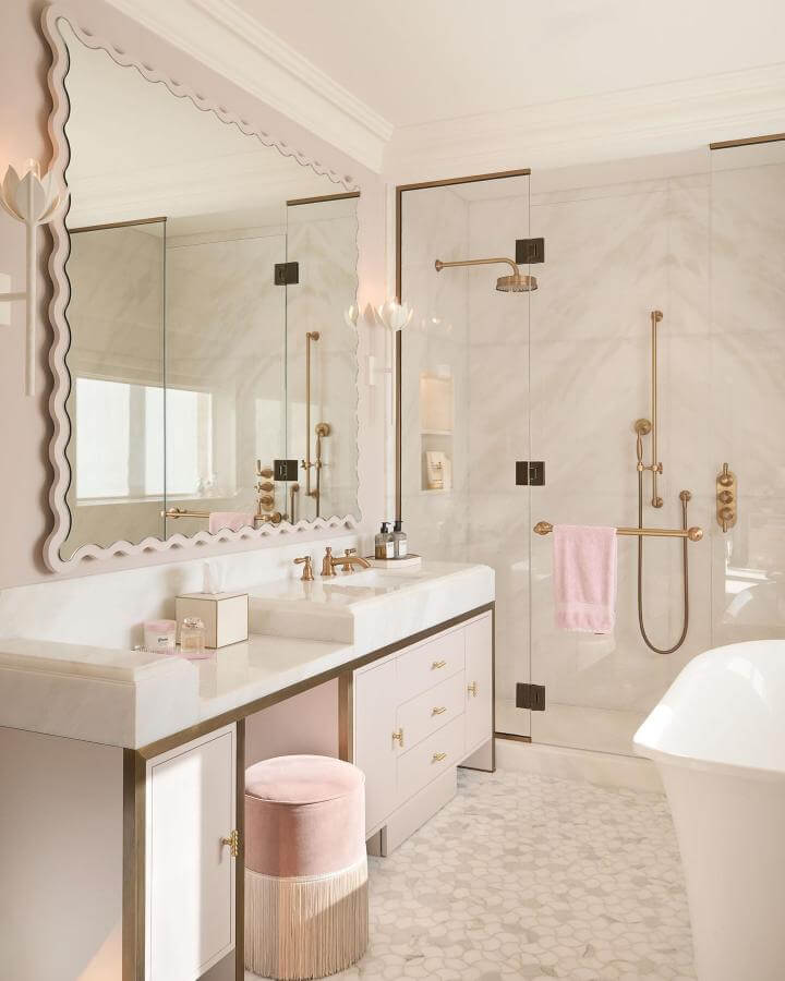blush pink velvet stool with fringe in a girly bathroom ideas setting by @laurahammett.interiors, soft feminine bathroom decor
