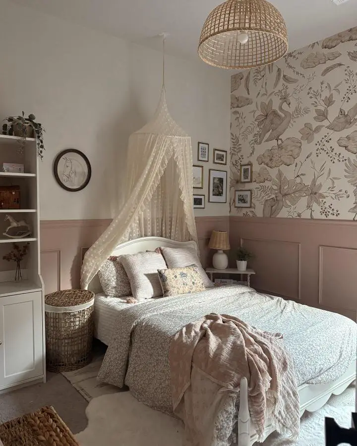 Romantic lace bed canopy from @missjessicanicolehome. Dusty rose wainscoting with floral wallpaper creates feminine bedroom atmosphere.