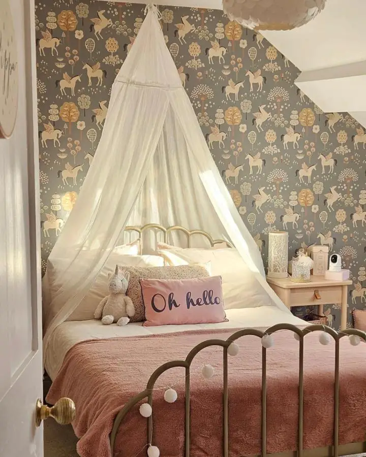 Charcoal unicorn wallpaper bedroom from @reecesreno. White canopy drapes over brass bed with pink accents.