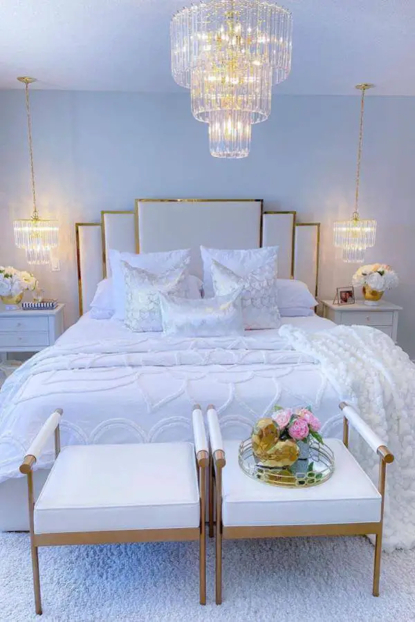 Tiered crystal chandelier bedroom from @inspiration_decor_by_edith featuring luxurious white and gold glam bedroom decor.