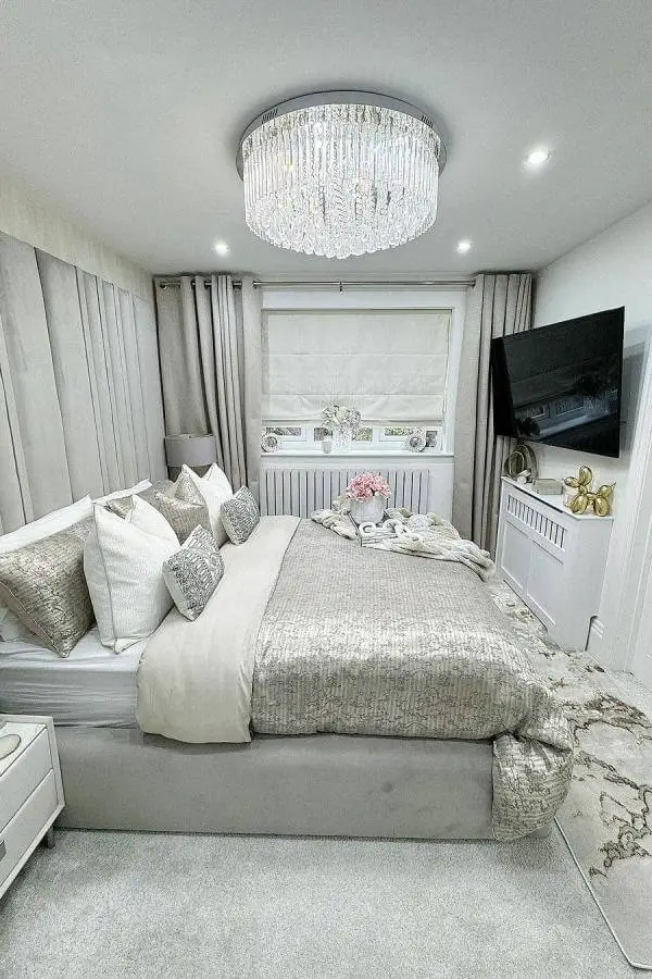 Chrome crystal flush-mount chandelier from @therugseller. Cascading crystals create dramatic ceiling lighting in neutral bedroom.