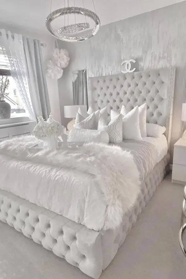 Luxurious gray tufted headboard from @vaneshomedecor with silver nailhead trim and white bedding ensemble.