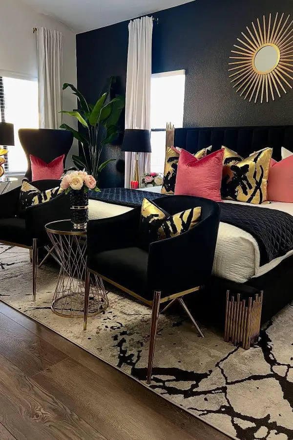 Navy upholstered bed with coral pillows from @wendywittwerdesign showcasing sophisticated glam bedroom decor styling with gold accents.
