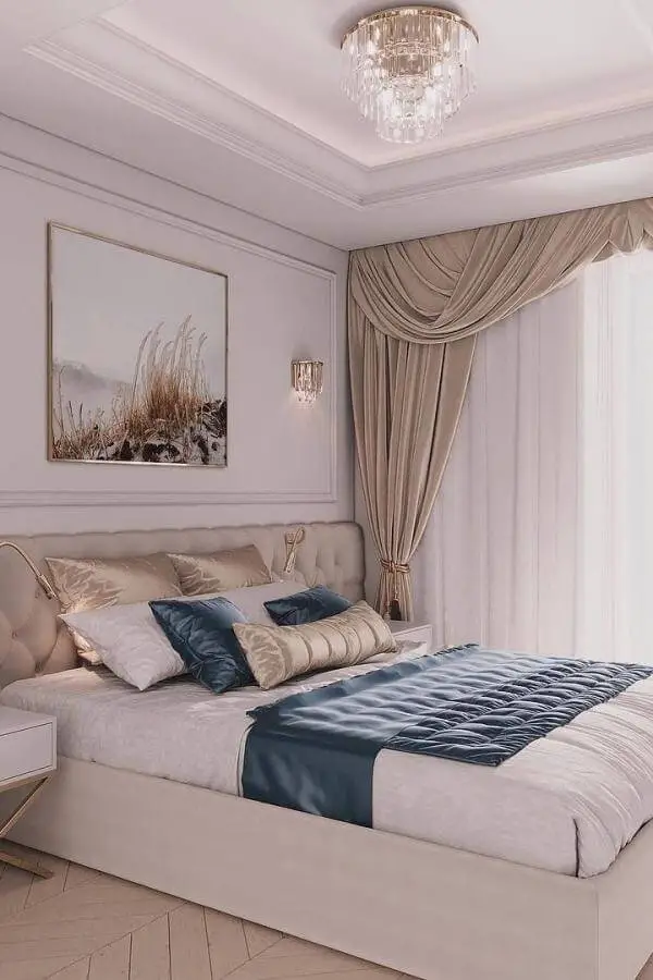 Luxurious teal and beige bedroom from @patrycja_okrutna_design featuring crystal chandelier and elegant curtains.