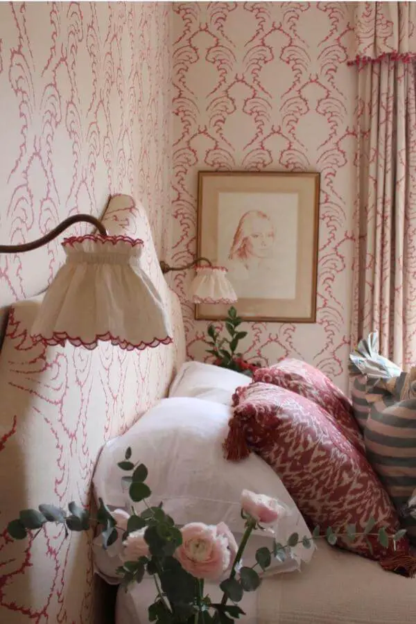 Raspberry patterned wallpaper and matching curtains from @alicecrawleyinteriors. Coordinated red scrollwork design with cream bedding.