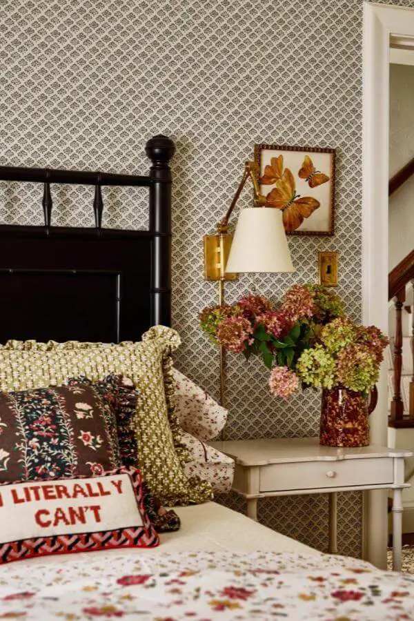 Taupe diamond lattice wallpaper from @katierosenfeld. Creates vintage backdrop for black bed frame and white nightstand.