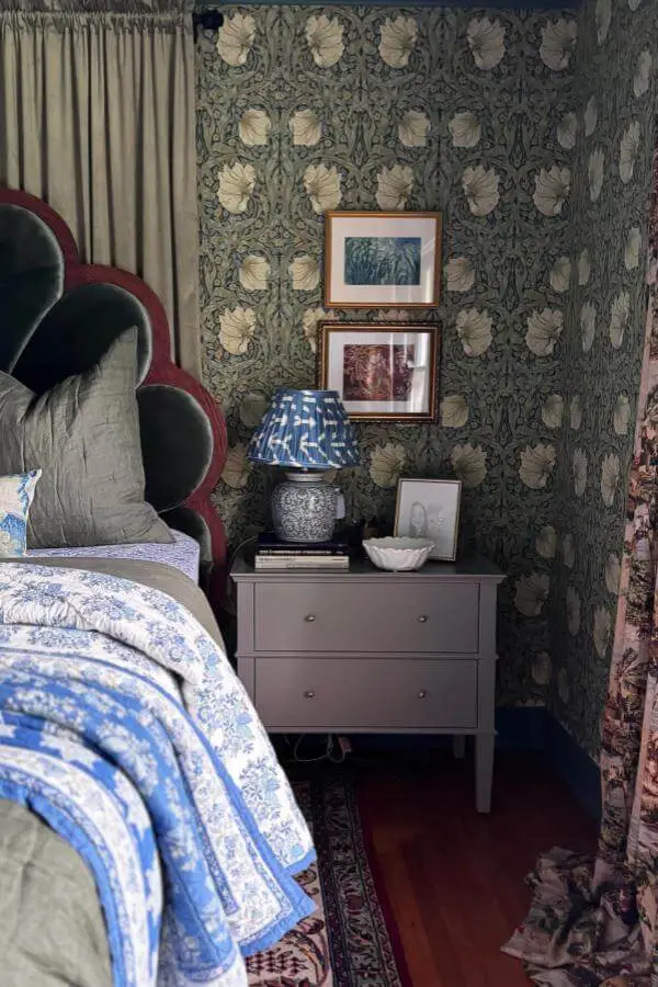 Sage green William Morris wallpaper from @embelline.designco. Vintage frames and blue ceramic lamp complete the look.