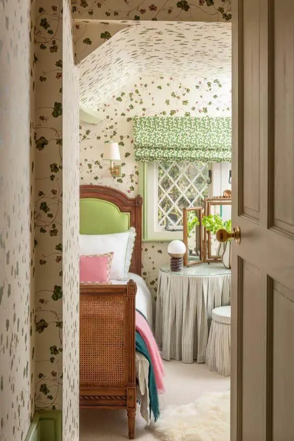 Vintage cane bed frame from @emma__ainscough featuring floral wallpaper and green accents perfect for grandmacore bedroom ideas inspiration.