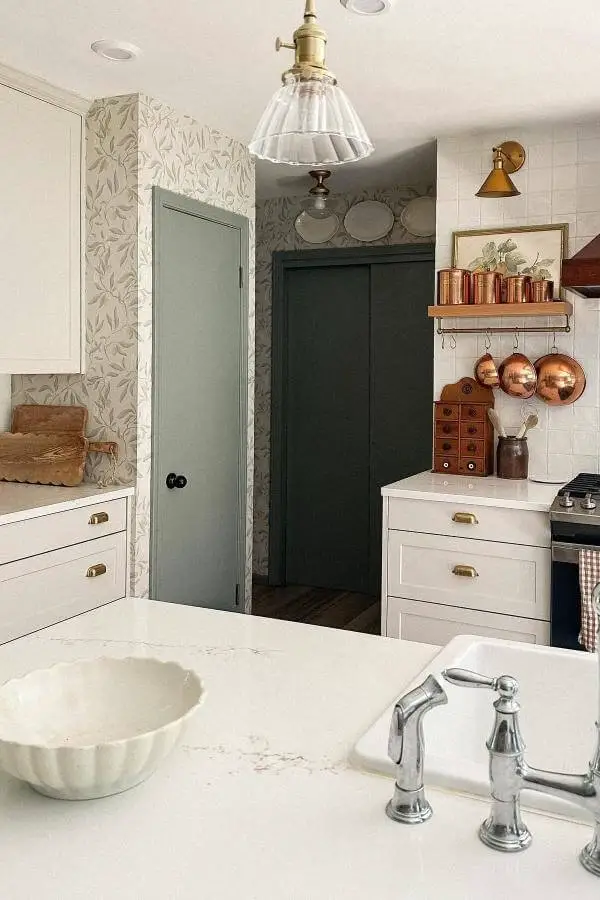 Warm copper cookware displayed on wooden rail from @michellemilowe. Classic white subway tile backdrop completes the vintage aesthetic.