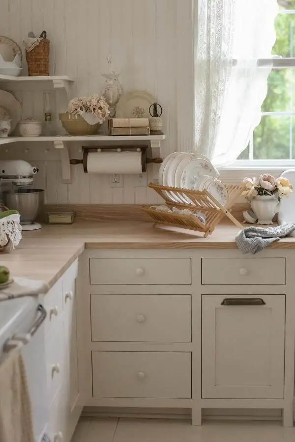 Bamboo dish rack with cream plates from @alliemboss. Natural wood adds warmth to neutral kitchen counter display.