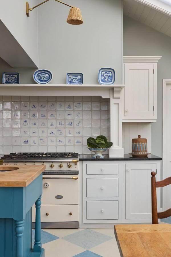 Blue and white ceramic tile backsplash from @houseandgardenuk featuring traditional motifs perfect for grandmacore kitchen ideas.