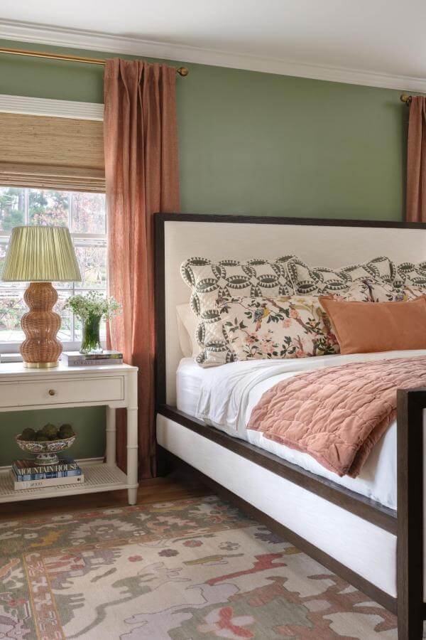 Layered green and terracotta bedroom textiles from @karrbick_design add cozy, stylish warmth and texture.