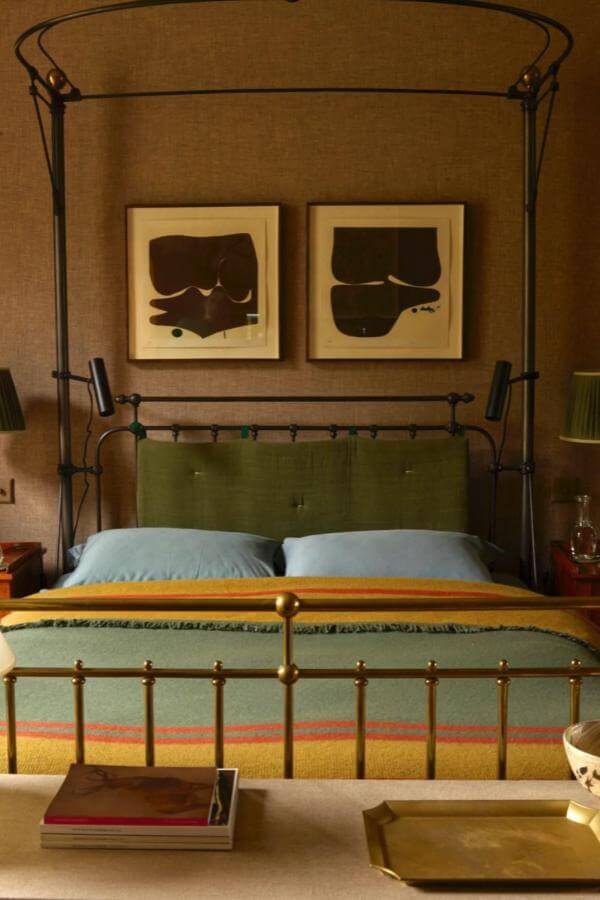 Iron canopy bed frame from @jonathan_reed_yorkshire. Elevates earthy retreat with green and terracotta bedroom accents.