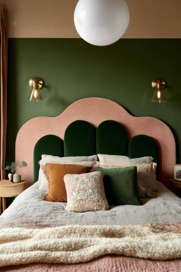 Luxurious scalloped velvet headboard from green and terracotta bedroom creates an artistic and cozy focal point.