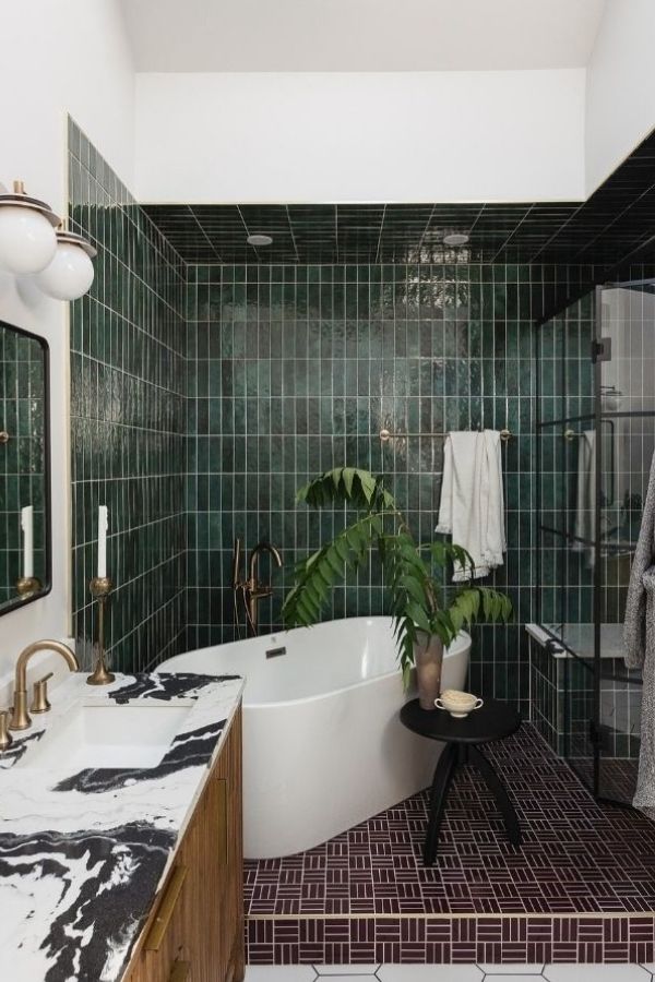 Elegant green bathroom featuring brass fixtures, showcasing modern green bathroom ideas.