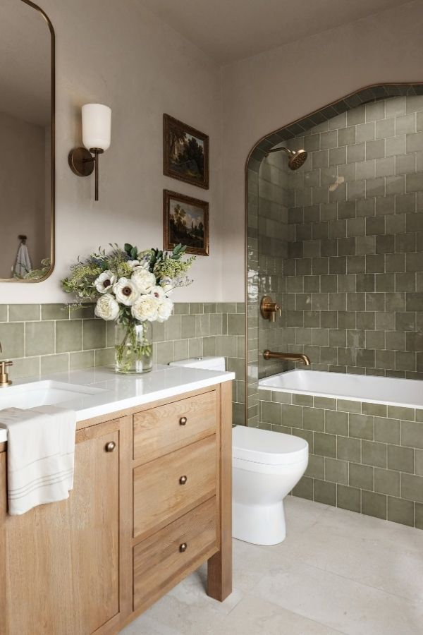 Arched shower entrance in a vibrant green bathroom, promoting green bathroom ideas.