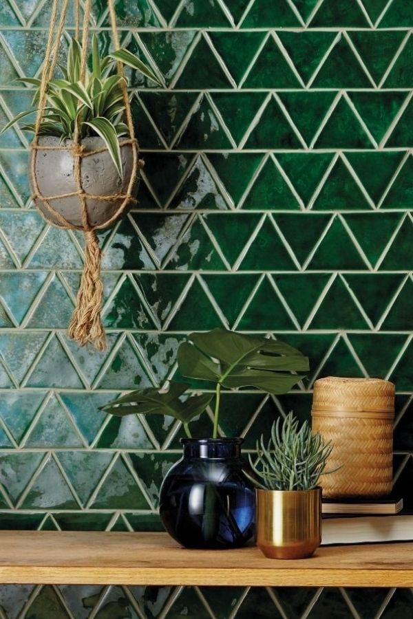 Green bathroom ideas with lush tiles, hanging plant, tranquil ambiance.