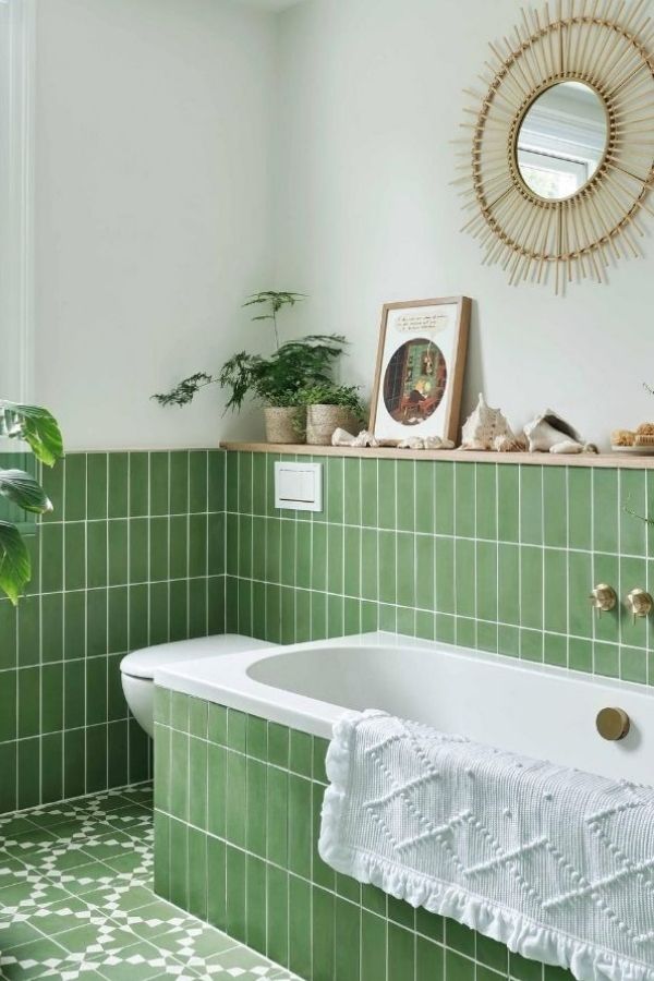 Green bathroom with striking geometric floor pattern; explore green bathroom ideas.