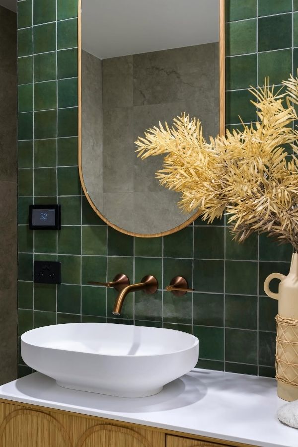 Emerald Green Bathroom with Bronze Faucet, a chic green bathroom idea.