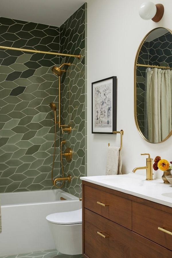 Brass fixtures elevate elegant bathroom; explore green bathroom ideas inspiration.