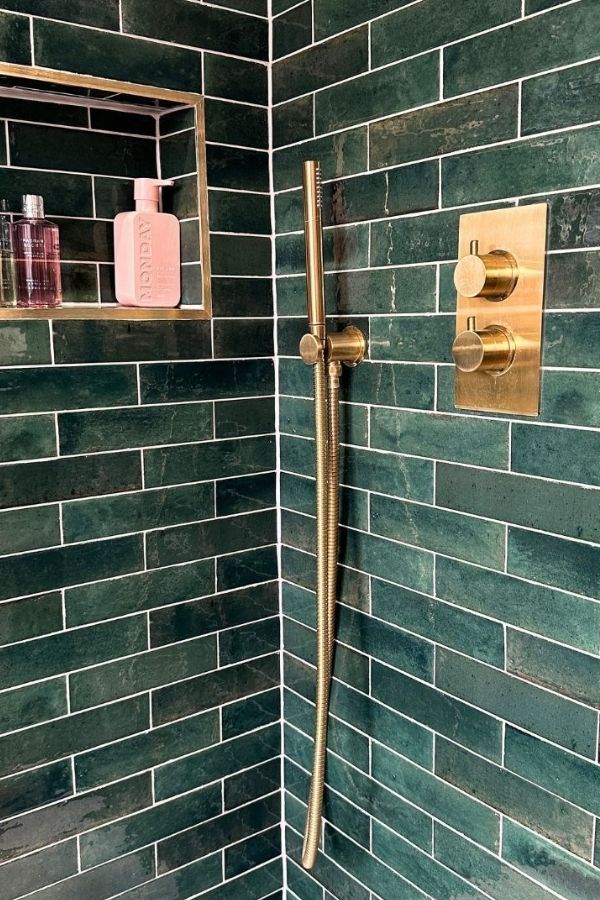 Green bathroom with shimmering brass fixtures; green bathroom ideas inspiration.