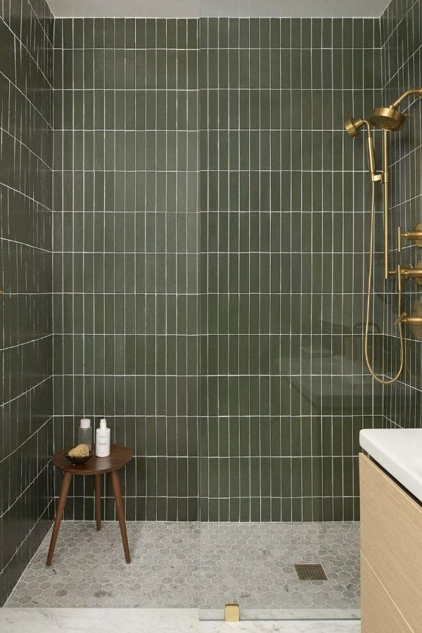 Luxurious green bathroom with brass accents; inspiring green bathroom ideas.