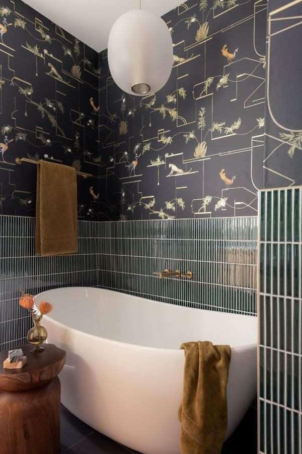 Leafy green tiles enhance nature-inspired bathroom; explore green bathroom ideas.