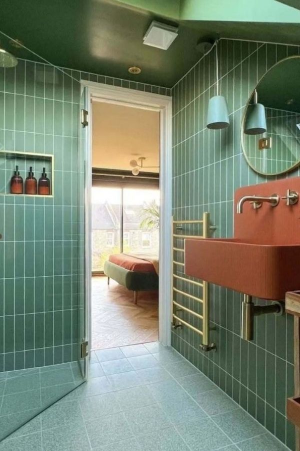 Green bathroom with vibrant red sink accent, inspiring green bathroom ideas.