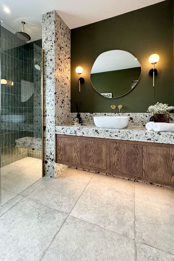 Green bathroom with terrazzo stone, elegant design; green bathroom ideas.