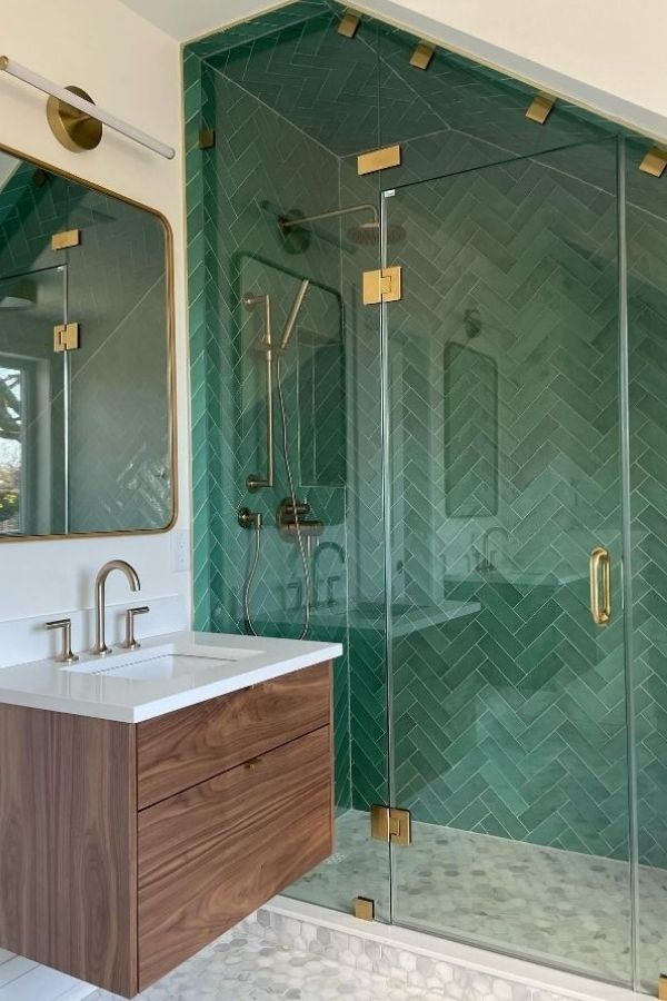 Emerald herringbone tiles highlight elegant green bathroom ideas beautifully.