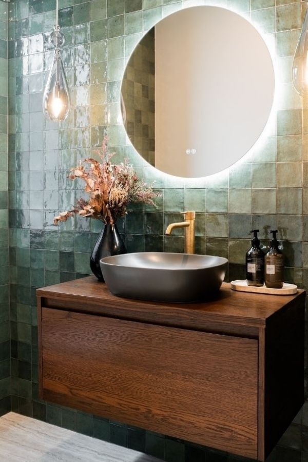 Elegant gold faucet enhances luxurious green bathroom; green bathroom ideas.