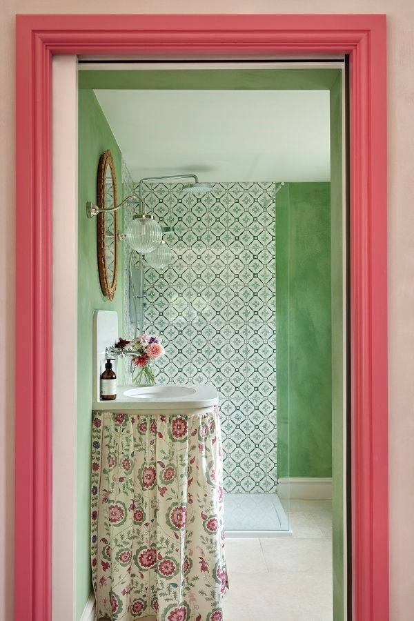 Green bathroom with intricate patterned shower tiles; inspiring green bathroom ideas.