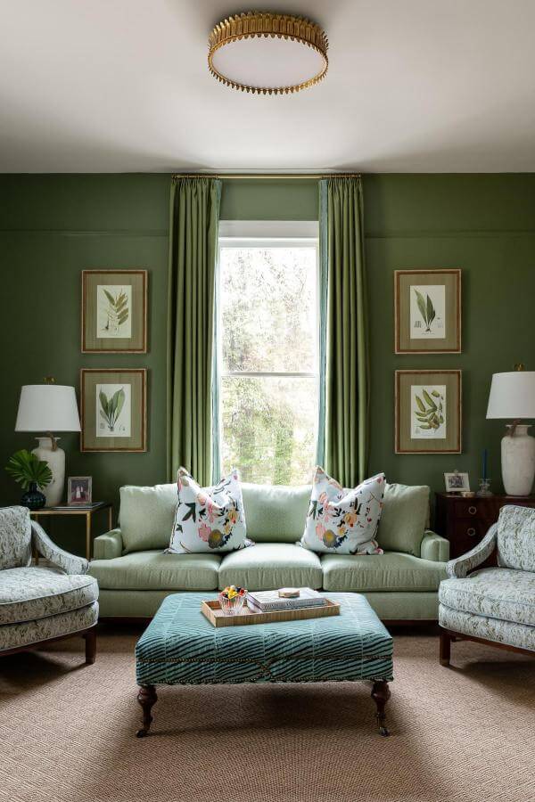 Vibrant botanical gallery wall from @yssinteriordesign. Creates lively focal point in green living room.