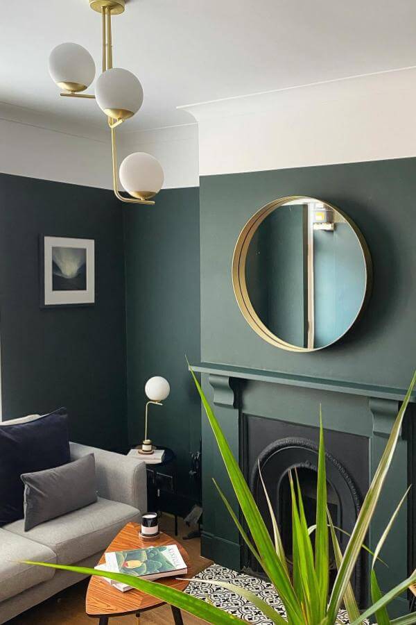 Striking gold mirror from @lick. Bold contrast elevates sophisticated green living room ideas.
