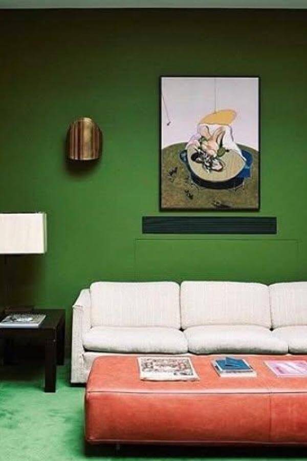 Vibrant green wall art commands this cozy living area from @wanderinginteriors. Bold art statement energizes the space.