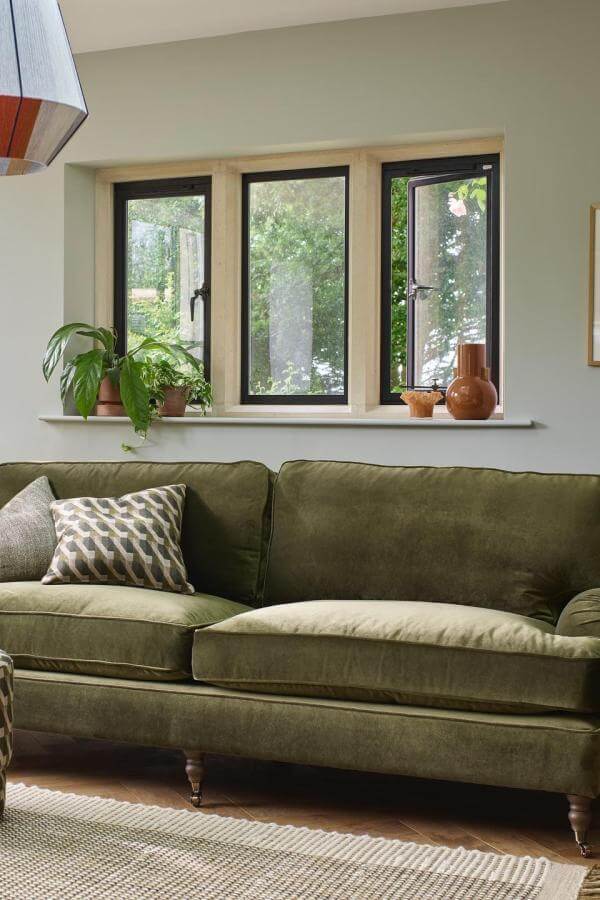Olive velvet sofa from @arloandjacob elevates green living room ideas with rich texture and bold color.