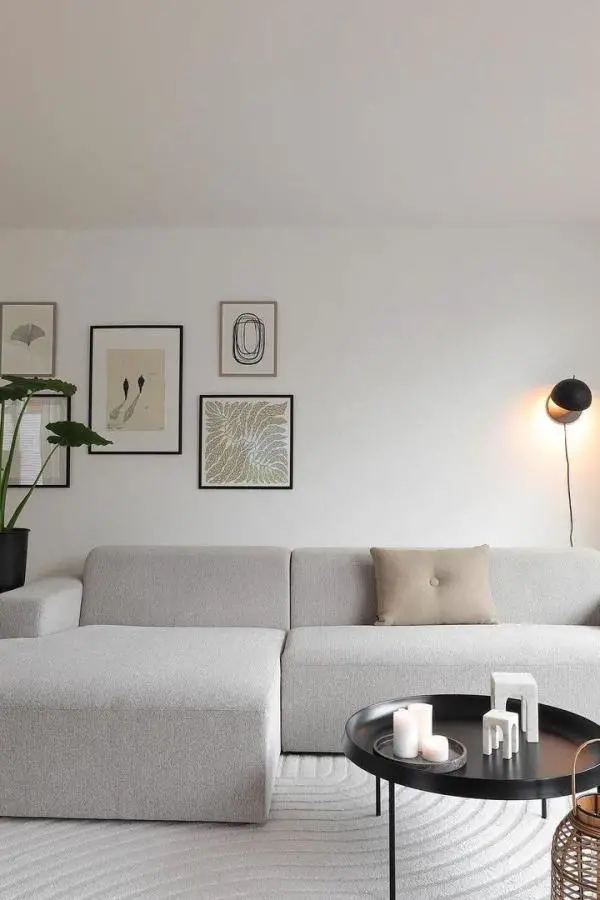 Neutral sectional sofa with curated gallery wall from @livingroomdecor_ showcasing grey minimalist living room ideas with clean lines.