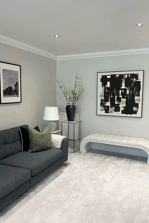 Neutral grey living room with minimalist furniture from @onlinecarpetsuk. Clean walls and recessed lighting create modern atmosphere.