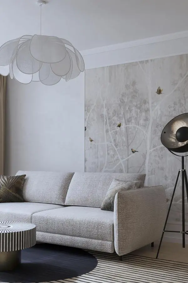 Botanical wallpaper accent wall from @artigi.interiors featuring birds and soft grey tones in modern living space.